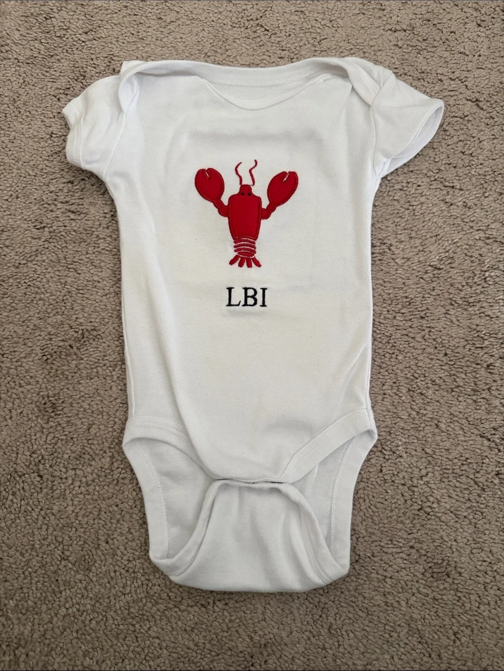 White Kids One-Piece Bodysuit with Red Lobster Graphic